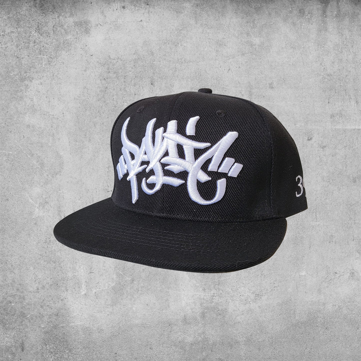 Panic 39 branded snap back hat in black with white puff embroidery.