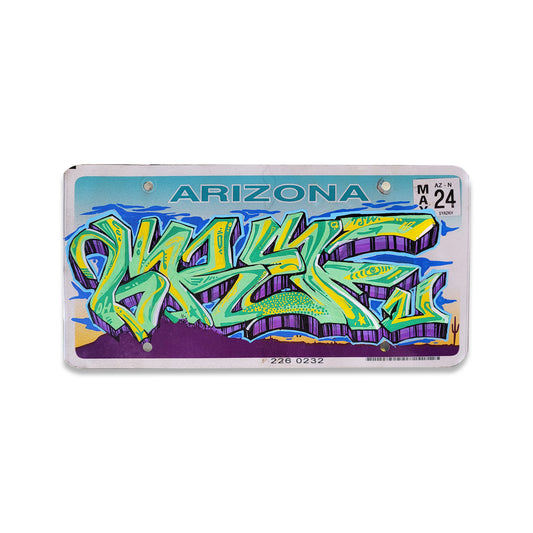 Arizona liscense plate with purple, blue and green graffiti writing