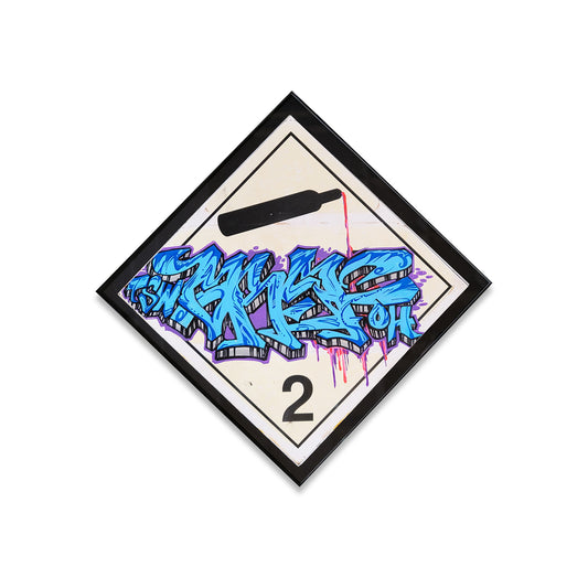 Black frame on white toxic sign with blue graffiti style sriting