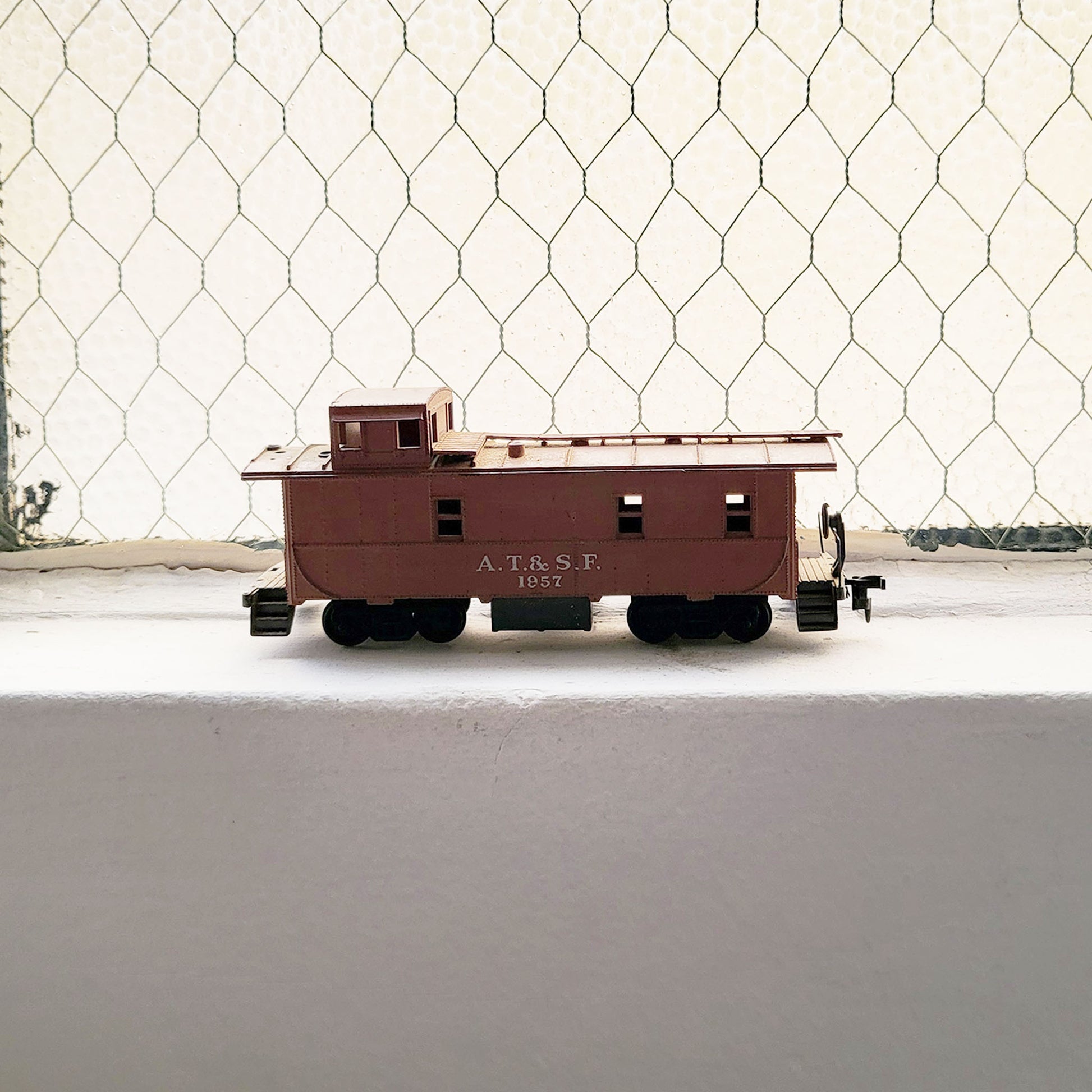 HO model toy 'AT&SF 1957' train caboose for graffiti writer gifts and train enthusiasts. 