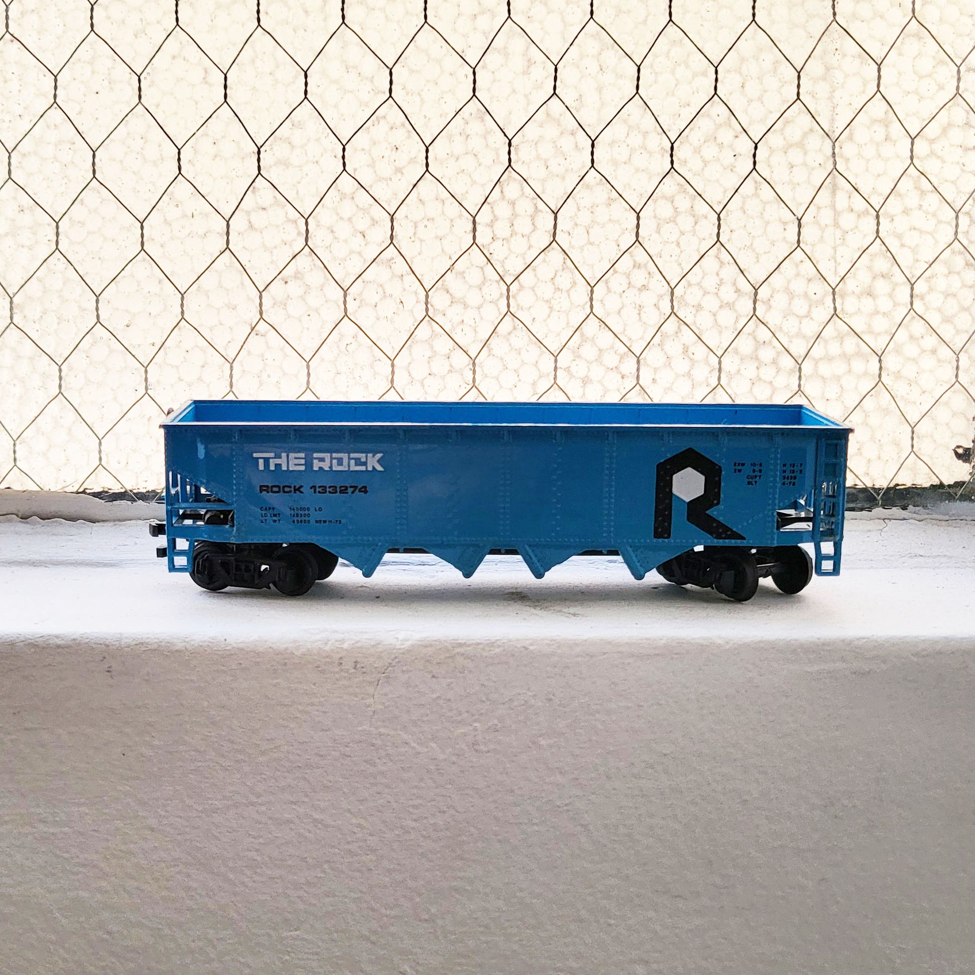 HO model toy 'The Rock' train open top hopper car for graffiti writer gifts and train enthusiasts. 