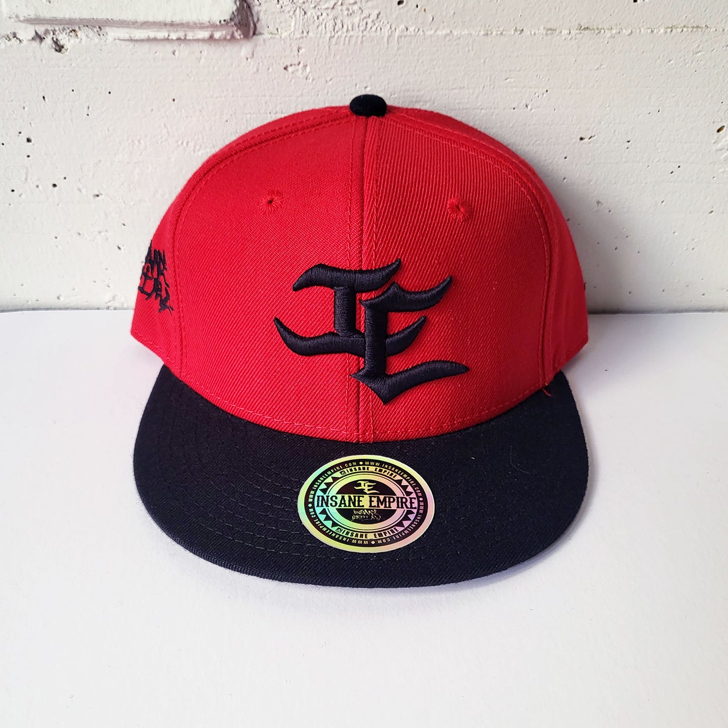 Local graffiti artist clothing brand inland empire black on red snap back hat