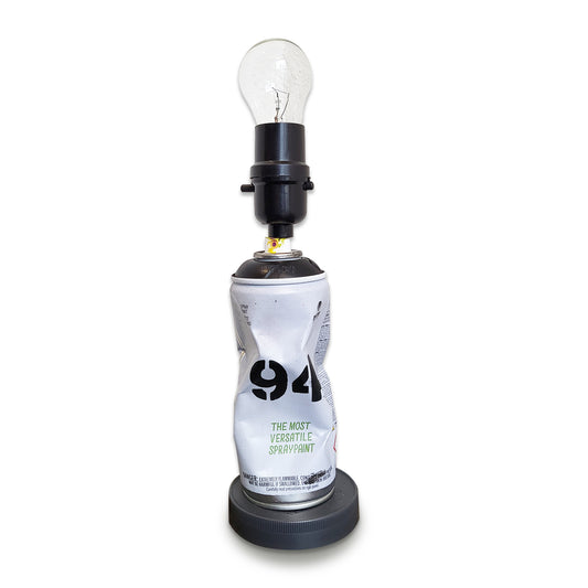 Crushed MTN 94 spray paint can lamp in black with stand and light bulb.