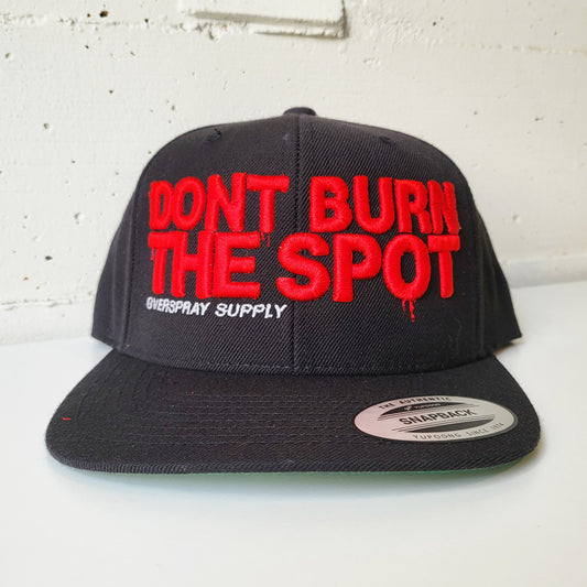 Overspray graffiti art supply shop branded snap back hat in puff red and black.