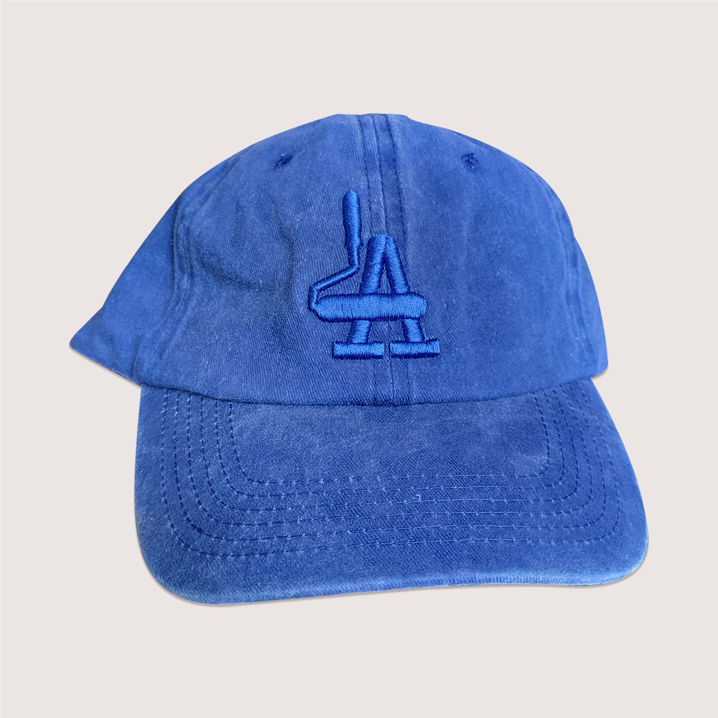Local graffiti brand unstructured cap in dodger blue with blue puff embroidery detail.